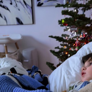 Child Gazing at Christmas Tree on Winter Morning