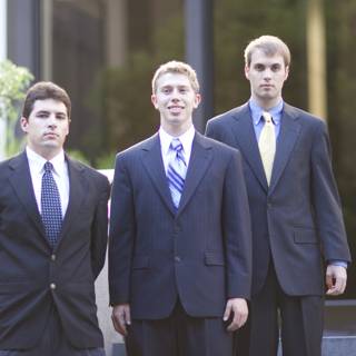 Three Men in Suits Strike a Pose