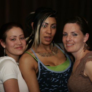 Three Friends Posing Together at Nightclub Event