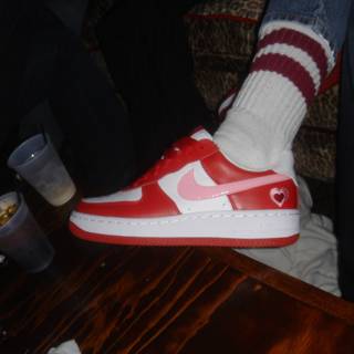 Red and White Nike Shoe on Hardwood
