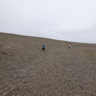 Children Climbing a Vast Coastal Sand Dune