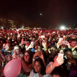 Capturing the Moment: Concertgoers Take Photos Under the Night Sky