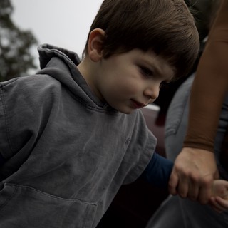 Young Boy in Thoughtful Moment at Indoor Setting