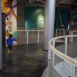 Young Explorer in Modern Science Museum Walkway