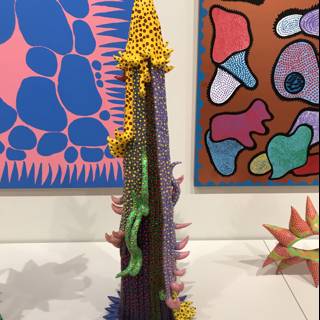Artistic Fusion: A Vibrant Sculpture Complements a Striking Painting