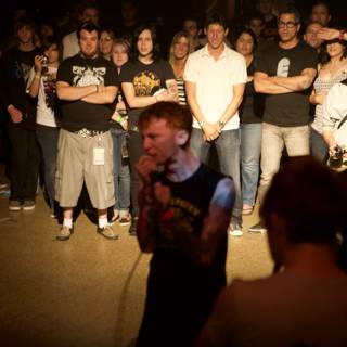 Tattooed Man Rocks Out with Crowd