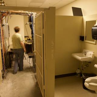 A Man Walks Through a Clinic Bathroom