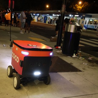 Coco Delivery Robot Navigates Busy City Sidewalk at Night