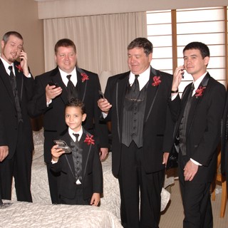 Groomsmen Checking Phones Before the Wedding Ceremony