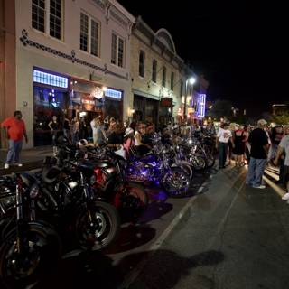 Motorcycle enthusiasts gather under the night sky