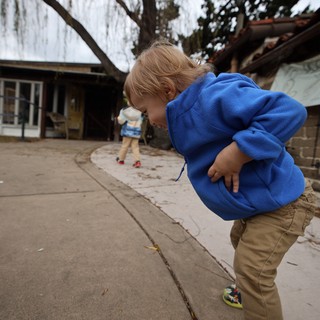 Young Boy in Blue Hoodie Playing Outdoors