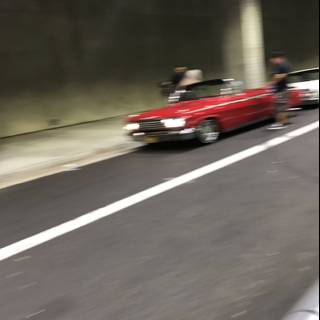 Red Sports Car Cruising Through the Tunnel