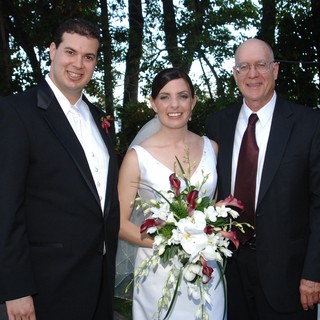 Joyful Wedding Trio Portrait in Garden Setting