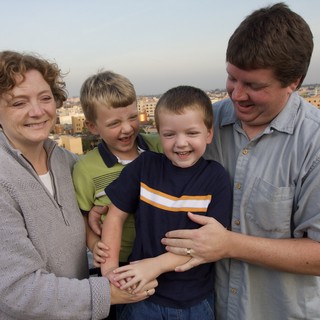 Happy Family Portrait on Urban Rooftop at Dusk