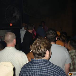 Speaker at Nightclub with Crowded Audience