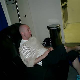 Bald Man Lounging on a Cozy Couch