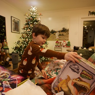 Young Boy Opening Christmas Presents on Holiday Morning