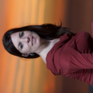 Woman in Red Against a Fiery Sunset Sky