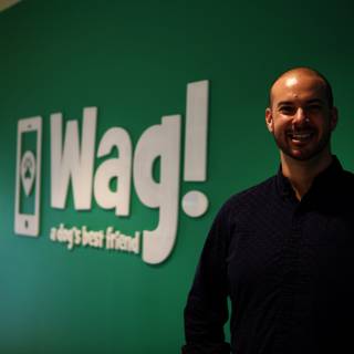 The Smiling Man in front of WAG Logo