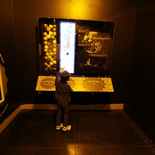 Child Exploring Interactive Space Exhibit at Science Museum