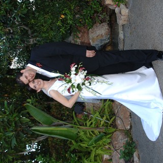 Bride and Groom Embrace in Lush Garden Setting