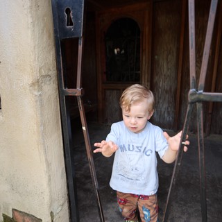 Young Boy Stepping Through Historic European Doorway