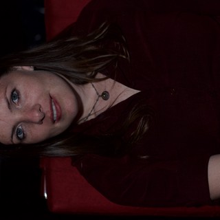 Woman in Red Chair with Pensive Gaze