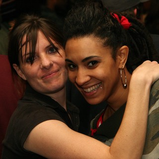 Two Friends Share a Warm Embrace at Party
