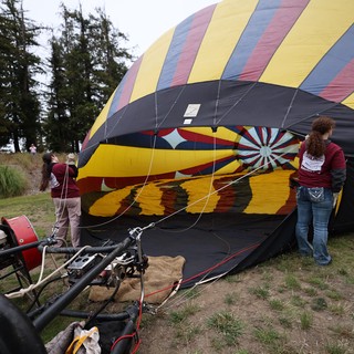 Volunteers Inflate Colorful Hot Air Balloon at Festival