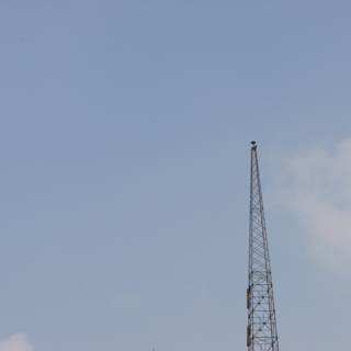 Towering Skyscraper with Radio Tower and Construction Crane