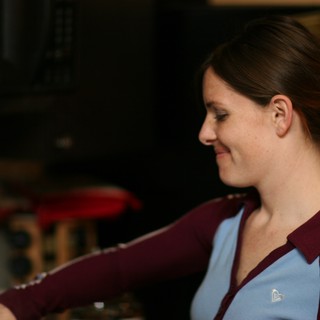 Young Woman Smiling in Burgundy Track Jacket