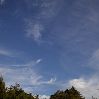 Wispy Cirrus Clouds Dance Across Blue Sky