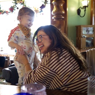 Joyful Mother-Daughter Moment at Restaurant