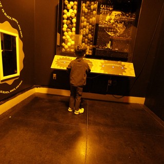 Child Exploring Interactive Science Exhibit in Museum