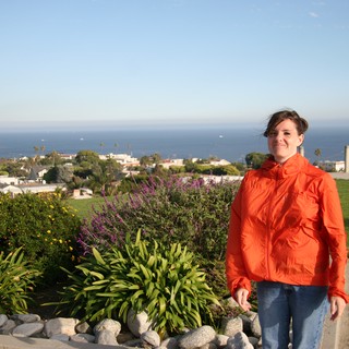 Woman in Orange Jacket Overlooking Coastal California Town