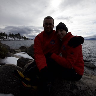 Couple Embracing at Snow-Dusted Lake Tahoe Shore