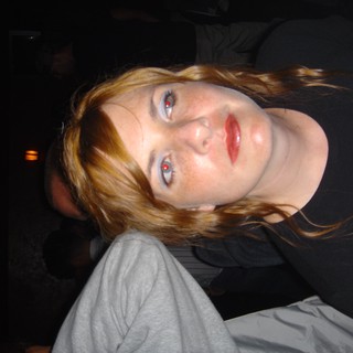 Redhead Woman with Blue Eyes at Night Event