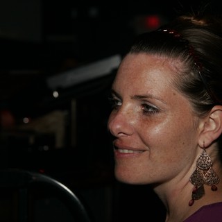 Woman in Profile Smiling at Nighttime Event