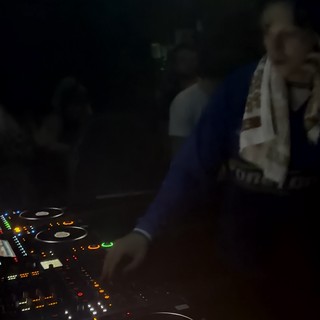 DJ Performance with Pioneer CDJ Controller at Night