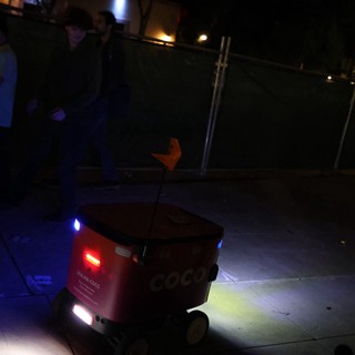 Coco Delivery Robot Navigates Sidewalk at Night Festival