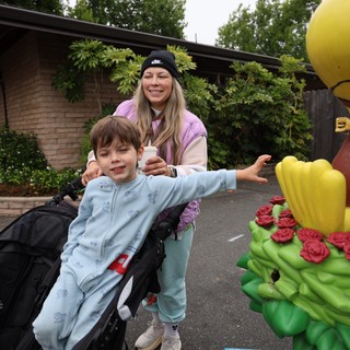 Child Reaches for Woodstock Statue at Balloon Festival