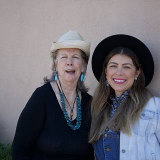 Two Women with Hats and Earrings Smiling for the Camera
