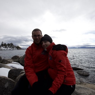 Couple Embracing by Snowy Lake Tahoe Shore