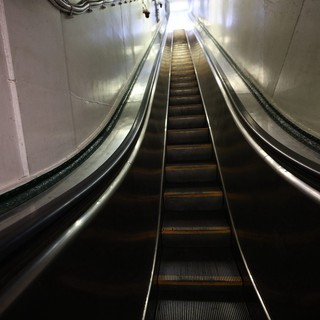 Deep Underground Escalator in Stark Tunnel Corridor