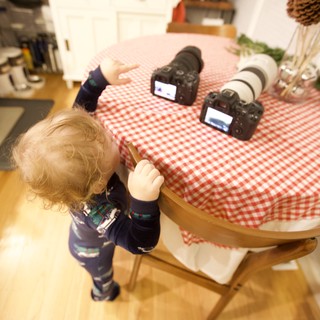Curious Toddler Explores Photography Equipment on Christmas