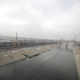 Graffiti-clad River with Train