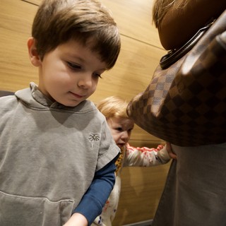 Children Exploring Museum Statue with Parent