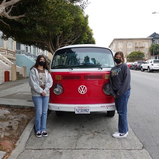 Friends Posing with Classic Red Volkswagen Bus