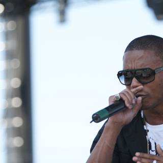 Lupe Fiasco with Microphone and Sunglasses