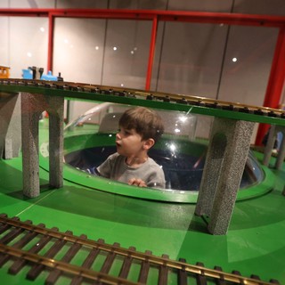 Child Exploring Interactive Train Museum Display